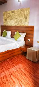 a bedroom with a large bed with a wooden headboard at Calangute Beach Front in Calangute