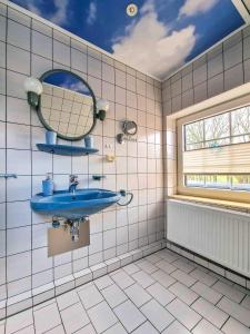 a bathroom with a blue sink and a mirror at Sonnendeck in Greetsiel