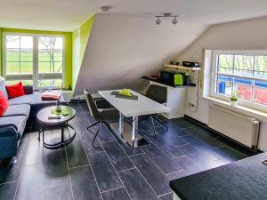 a living room with a couch and a table at Sonnendeck in Greetsiel