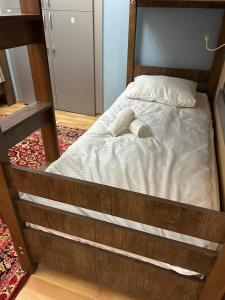 a bed with a pair of shoes sitting on it at HOSTEL124 in Baku