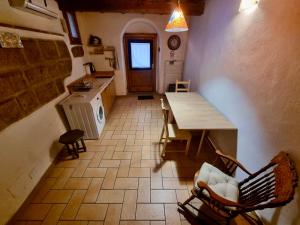 a kitchen with a table and a counter in a room at Francigena Maison in Sutri