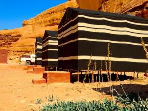 a row of black and white buildings in the desert at Wadi rum view camp in Wadi Rum