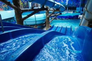a blue water slide in a water park at Aquapark Hotel & Villas in Yerevan