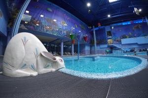 a inflatable elephant next to a swimming pool at Aquapark Hotel & Villas in Yerevan