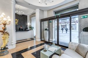 a lobby with a white couch and a table at Artemisia Palace Hotel in Palermo