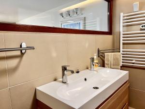 a bathroom with a white sink and a mirror at The Sun - by Caparica Villas in Costa da Caparica