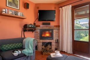 ein Wohnzimmer mit einem Sofa und einem Kamin in der Unterkunft Casa ideal para familia en Ribadesella Africa in Cuerres