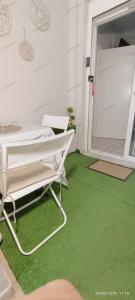 a room with a green floor and a projection screen at Georgias house 7 min from Athens airport in Artemida