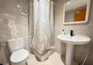 a bathroom with a toilet and a sink at Nuevo apartamento en Sant Carles de la Ràpita in Sant Carles de la Ràpita +15 photos