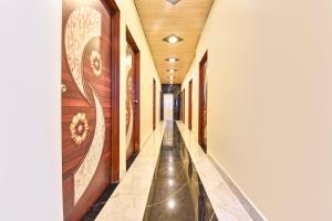 a hallway with a long corridor with wooden walls at FabHotel Spark in Jaipur