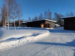 a snow covered road with a building in the background at Villa Pajunkissa in Rovaniemi