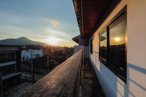 a balcony of a building with the sunset in the background at Kamala Havana in Kamala Beach