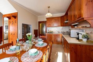 a kitchen with a table and chairs in a kitchen at Monte Balaton in Paloznak