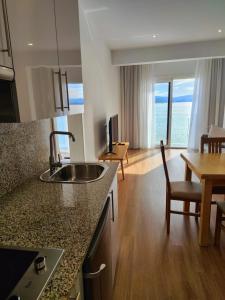A kitchen or kitchenette at Apartamentos La Toja