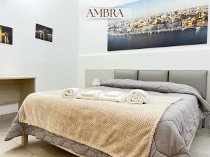 a bedroom with a bed with towels on it at Residence Lori in Brindisi