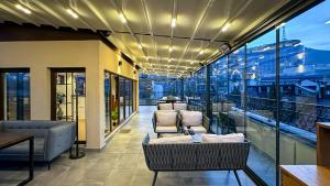 a balcony with couches and chairs on a building at Silver 39 Corner Hotel in Tbilisi City
