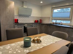 a kitchen with a wooden table and a dining room at Alex Design Appartment in Rastatt