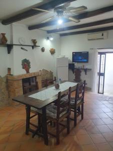 a dining room with a wooden table and chairs at Nonna Elena in Rodi Garganico