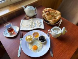 a table with a plate of eggs and a pie at HOSTEL124 in Baku