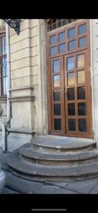 a set of stairs leading to a wooden door at HOSTEL124 in Baku