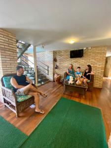 a group of people sitting in a living room at POUSADA TAIEIRAS in Maragogi