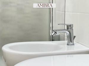 a bathroom sink with a faucet next to a toilet at Residence Lori in Brindisi