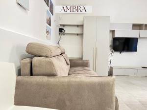 a living room with a chair and a television at Residence Lori in Brindisi