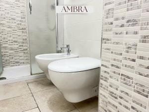 a bathroom with a toilet and a sink and a shower at Residence Lori in Brindisi