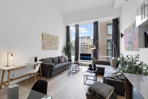 a living room with a couch and a table at LiV MTL Downtown Montreal Spacious Suites in Montreal