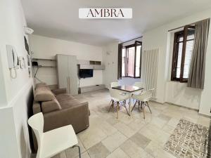a living room with a couch and a table and chairs at Residence Lori in Brindisi