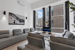 a living room with a couch and a table at LiV MTL Downtown Montreal Spacious Suites in Montreal
