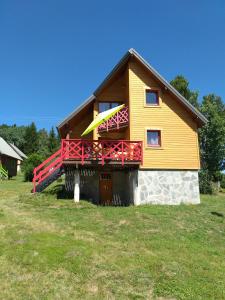 拉菲克拉的住宿－Chalet nordique 31，房屋上设有黄色和红色的阳台