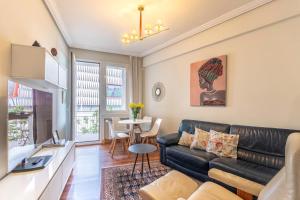 a living room with a couch and a table at San Mames Apartment - Free Parking in Bilbao