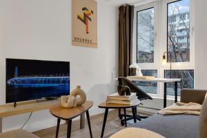 a living room with a tv and a couch at LiV MTL Downtown in Montréal