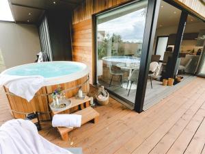 a hot tub on the deck of a house at 2 Bed in East Bergholt 82399 in East Bergholt