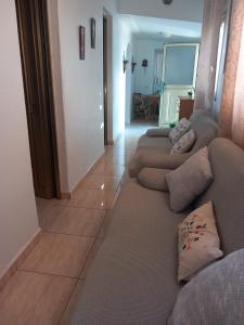 a living room with two couches sitting on a tile floor at Casa rural entre la naturaleza Gomera in El Cercado