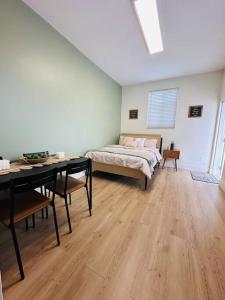 a bedroom with a bed and a desk and a table at Miami Coral Gables Studio near Airport and Beaches in Miami