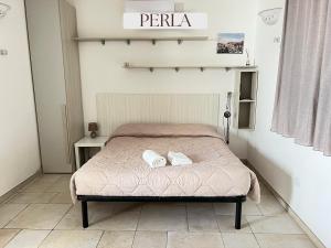 a bedroom with a bed with two towels on it at Residence Lori in Brindisi