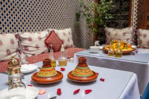 a table with two tea sets on top at Riad Dar Rabha in Fez
