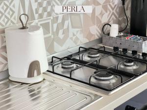 a stove top with a roll of paper towels on it at Residence Lori in Brindisi