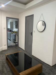 a living room with a mirror on the wall at Holiday Plus - Holmfield Road in Blackpool +33 photos