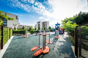 a playground with orange equipment in a park at Nessebar Fort Club Apartments in Sunny Beach