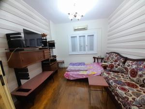 a living room with a couch and a piano at قصرالنيل in Cairo