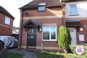 a red brick house with a black door at Palmers Leaze, Comfortable house close to Aztec West in Bristol