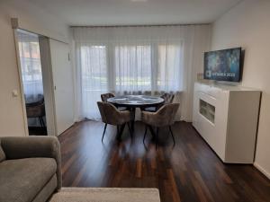 a living room with a table and chairs in a room at Apartment Amanda in Augsburg