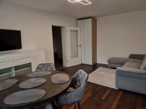 a living room with a table and a couch at Apartment Amanda in Augsburg +7 photos