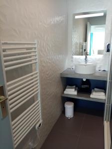 a bathroom with a sink and a mirror at Best Western Hôtel Royan Océan in Royan