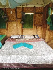 a large bed in a room in a tent at Tanna Eagle twin volcano view tree house in White Sands