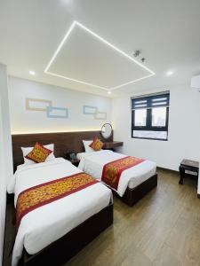 a hotel room with two beds and a window at Gia Kiên Hotel in Quy Nhon