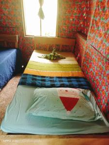 a bedroom with two twin beds in it at Tanna Eagle twin volcano view tree house in White Sands